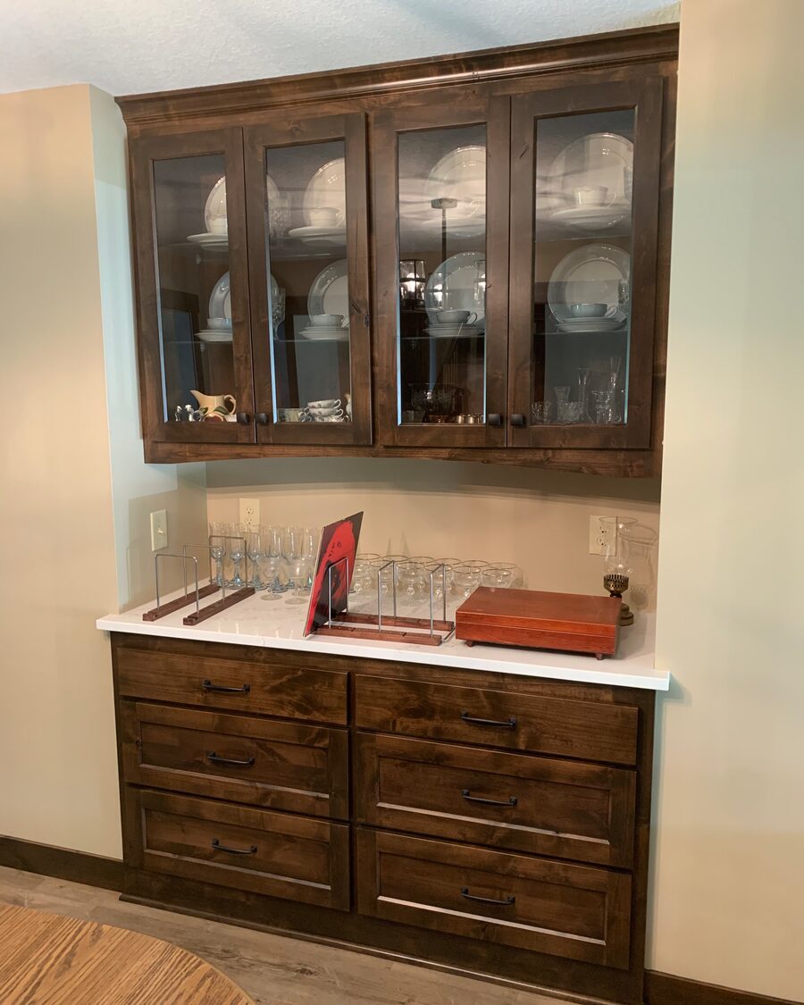 Stained built-in hutch with glass-front upper cabinets over a drawer base